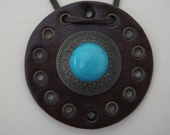 Handmade Necklace With Large Leather Pendant With Turquoise Stone And Decorative Metal Surround And Eyelet Details.