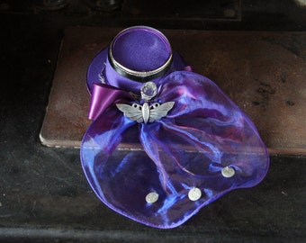 One Of A Kind Steampunk Mini Riding Hat In Purple With Flower, Moth and Glass Orb Detail And Organza Overspill With Metal Coin Decoartion