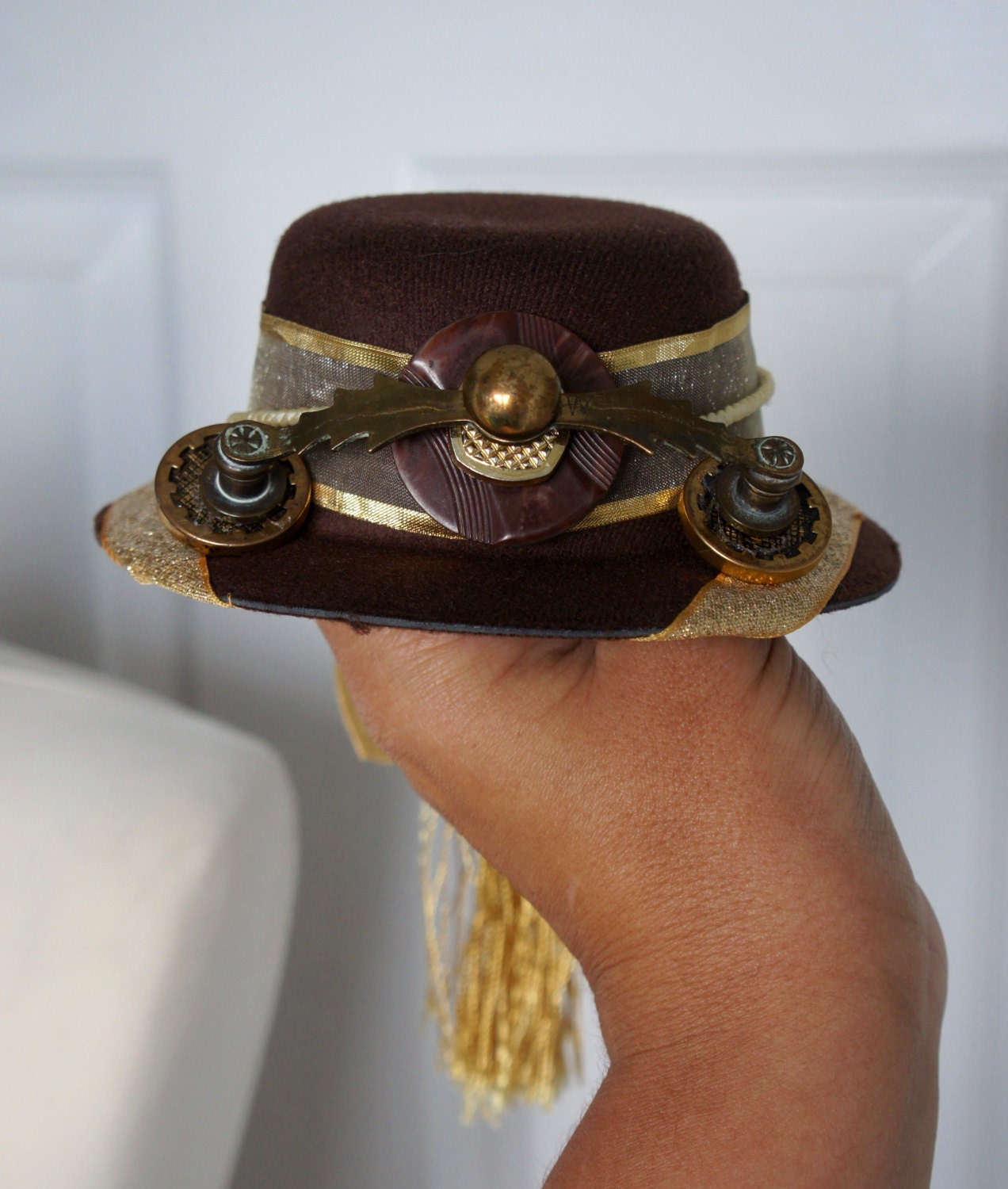 One Of A Kind Steampunk The Brass Teleporter Ornamented Mini Riding Hat Fascinator In Brown With Gold Ribbon Band And Gold Tassel Overspill