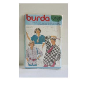 May include: Burda sewing pattern number 6431, featuring three different shirt designs. The first shirt is a blue and white plaid, the second is a blue and white striped shirt, and the third is a blue and white checkered shirt.