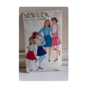 May include: A vintage New Look sewing pattern envelope featuring illustrations of girls in skirts and blouses. The envelope is off-white with the text "NEW LOOK" at the top. The pattern number is 6429.