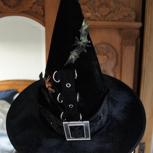 The Batty Black Witches Hat With Buckle And Metal Loop And Eyelet Braid And Resident Bat And Spider