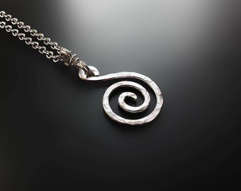 May include: Silver necklace with a hammered spiral pendant. The pendant is a simple, elegant design.