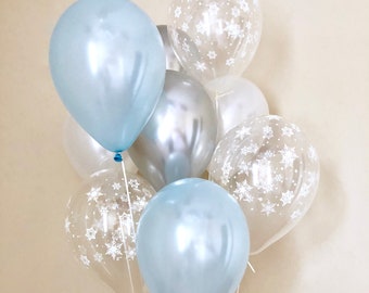 May include: A cluster of blue and white balloons with snowflake patterns. The balloons are tied together with clear strings.