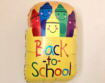 May include: A yellow foil balloon shaped like a crayon box with the words "Back-to-School" and six colourful crayons with smiling faces.