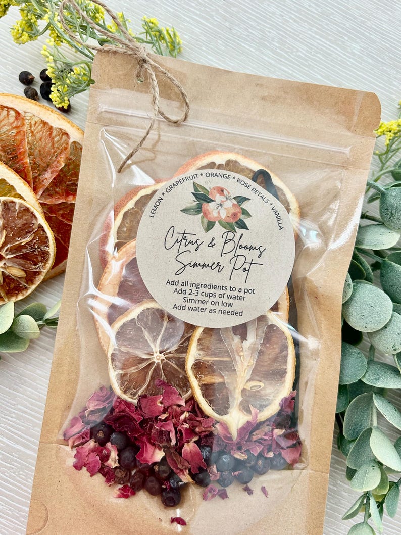 Pu&ograve; includere: Un sacchetto di carta marrone con una finestra di plastica trasparente, contenente frutta di agrumi secca, petali di rosa e bacche di ginepro. Un adesivo rotondo sul sacchetto recita "Citrus & Blooms Simmer Pot" con istruzioni per l'uso: "Aggiungere tutti gli ingredienti in una pentola, Aggiungere 2-3 tazze d'acqua, Far sobbollire a fuoco lento, Aggiungere acqua se necessario".