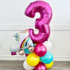 May include: A pink number three balloon with a white roller skate balloon attached to the bottom. The balloons are surrounded by smaller balloons in white, yellow, pink, and blue.
