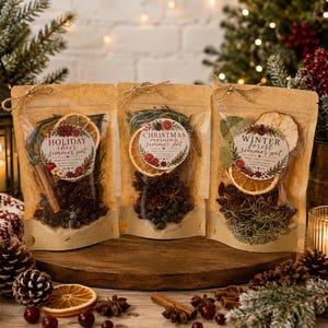 May include: Three kraft paper pouches containing dried fruit, spices, and herbs for stovetop simmering. Each pouch features a circular label reading Holiday Cheer, Christmas Morning, or Winter Forest Simmer Pot with botanical illustrations.