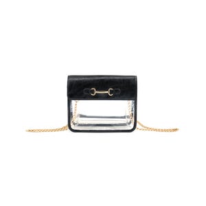 May include: Black crossbody bag with a clear plastic front panel and a gold chain strap. The bag has a gold metal clasp.