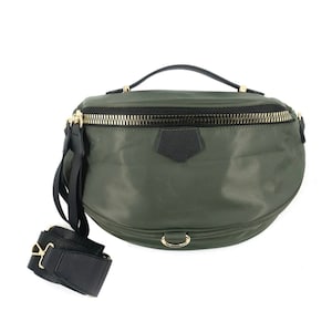 May include: A green nylon fanny pack with a black adjustable strap and a gold zipper. The bag has a top handle and a gold ring on the front.