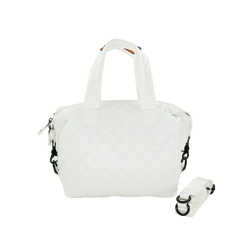 May include: White quilted tote bag with black straps and a detachable shoulder strap. The bag has a zipper closure and a diamond quilted pattern.
