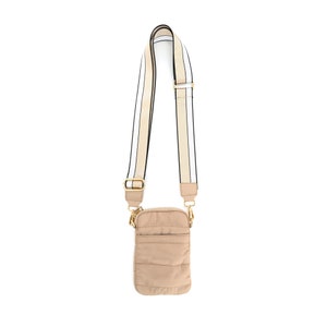 May include: A beige quilted phone crossbody bag with a black and white striped strap. The strap has gold hardware.