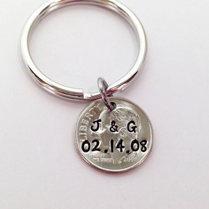 May include: Silver keychain with a dime charm engraved with "J & G 02.14.08"