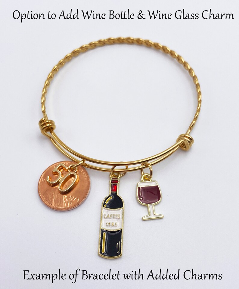 May include: Gold bangle bracelet with a penny charm with the number 30 on it, a wine bottle charm, and a wine glass charm.  Option to Add Wine Bottle & Wine Glass Charm. Example of Bracelet with Added Charms.