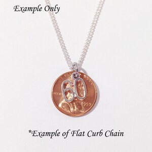 May include: A silver-colored necklace with a penny pendant. The penny has a silver charm with the number 60 attached. The necklace chain is silver and the background is white. The text "Example Only" and "*Example of Flat Curb Chain" are visible.
