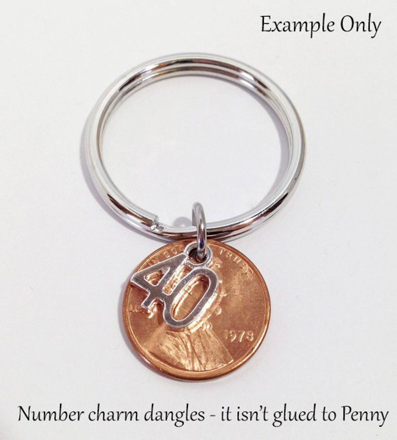 May include: A silver key ring with a copper penny charm. A silver number 40 charm dangles from the penny. The penny is dated 1973. The text "Example Only" is at the top and "Number charm dangles - it isn't glued to Penny" is at the bottom.