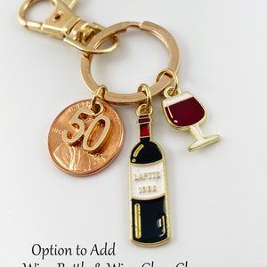 May include: Gold key chain with a 50th anniversary penny, a wine bottle charm, and a wine glass charm. Option to add wine bottle and wine glass charm.