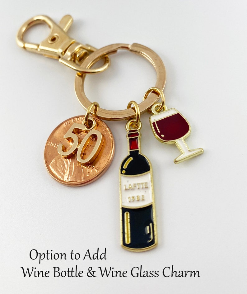 May include: Gold key chain with a 50th anniversary penny, a wine bottle charm, and a wine glass charm. Option to add wine bottle and wine glass charm.