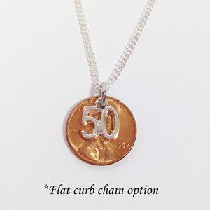 May include: A silver chain necklace with a copper penny pendant. The penny has a silver charm with the number "50" attached. The text "*Flat curb chain option" is at the bottom of the image.