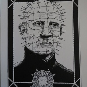 May include: Black and white ink drawing of a man with pins in his head, a grid pattern, and a decorative emblem. The artwork is signed "Jenn Park MacabrePark Imagery" and dated "5.23.18".