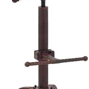 May include: A white ceramic mug with a black handle and the text "But First, Coffee" in a bold, black font. The mug is set against a neutral background, highlighting its simple design.