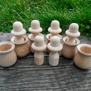 May include: A set of eight wooden stacking toys, featuring a variety of shapes and sizes. The toys are made of natural wood and are perfect for developing fine motor skills and hand-eye coordination.