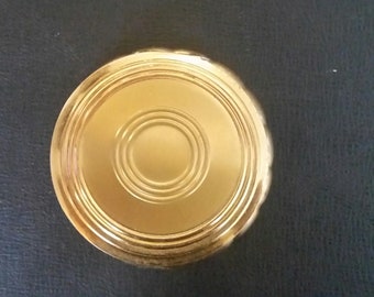 Vintage Goldtone Majestic Rd Powder Compact w/concentric Top Pattern & Rear Sunburst Pattern.Signed Majestic. Powder Puff w/Majestic Ribbon