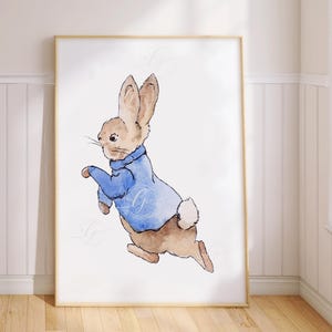 May include: A watercolour painting of a brown rabbit wearing a blue jumper. The rabbit is hopping and has its ears up. The background is white.