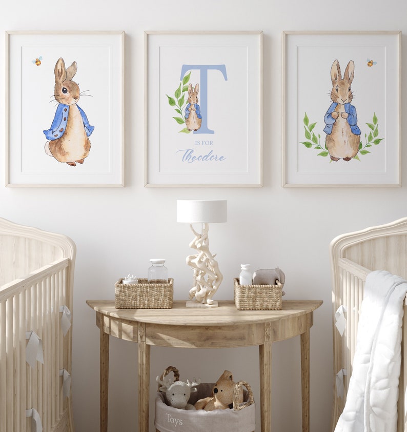 May include: Three framed prints featuring a watercolour illustration of Peter Rabbit in a blue jacket. The middle print has the letter T and the text "T is for Theodore".