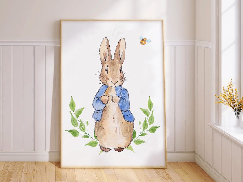 May include: A watercolour illustration of Peter Rabbit, a brown rabbit wearing a blue jacket, standing in front of green leaves. A small yellow bee is flying above the rabbit.