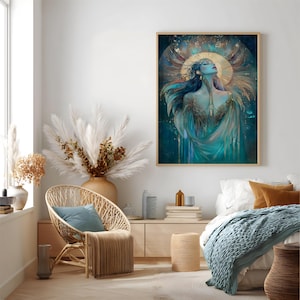 May include: A framed art print depicting a woman with flowing blue hair and teal attire. The artwork features a gold halo and accents, set against a dark teal backdrop. The print is presented in a light-coloured wooden frame.