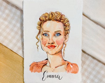 May include: A watercolor painting of a woman with blonde hair and blue eyes. She is wearing a peach-colored dress and smiling. The painting is signed "Emma".
