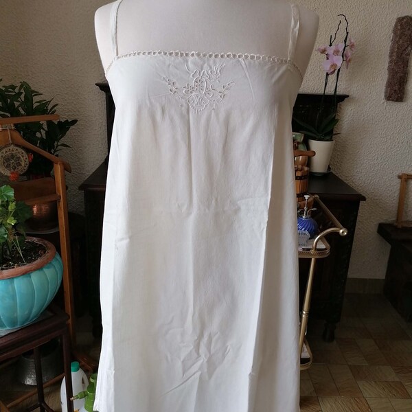 French romantic cotton nightgown, embroidered lace in hand, French farm.Vintage of the 1920s