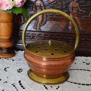 Vintage copper and brass heater, in the shape of a flower basket. Vintage from the 1950s. A souvenir of traditional life.