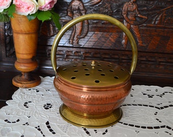 Vintage copper and brass heater, in the shape of a basket of flowers. Vintage from the 1950s. Souvenir of traditional life.