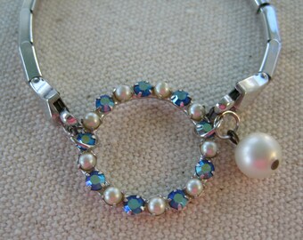 Repurposed clear vintage rhinestone swirl and silver tone stetch watchband bracelet