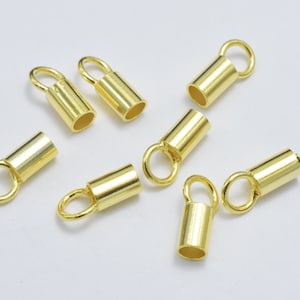 May include: Eight gold-toned metal end caps with a loop at the top. The end caps are cylindrical in shape and have a smooth finish.