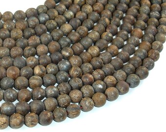 May include: A strand of brown and gray round beads, made of natural stone. The beads are smooth and have a slightly textured surface.