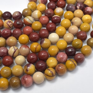 May include: A strand of round, multi-coloured gemstone beads. The beads are a mix of red, yellow, and brown with white and grey marbling.