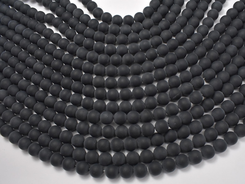 May include: A strand of black matte round beads. The beads are uniform in size and have a smooth, polished finish.