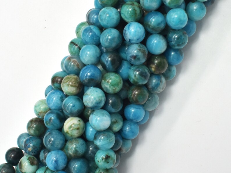 May include: A strand of round, blue and green gemstone beads. The beads have a mottled, marbled appearance.