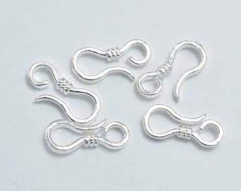 May include: Several silver-coloured hook and eye clasps. Each clasp has a curved hook and a loop, joined by a textured bead. These clasps are suitable for jewellery making and various craft projects.