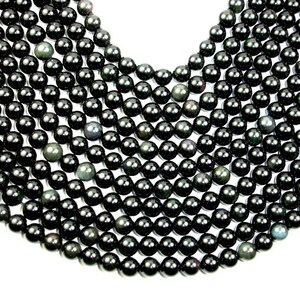 May include: A strand of black obsidian beads, each bead is round and smooth. The beads have a slight shimmer to them.