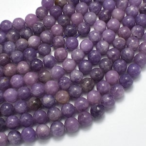 May include: Close-up of a collection of round, purple beads. The beads vary in shades of purple, from light lavender to deep violet. They appear to be strung together, suggesting they are for jewellery making or crafting. The beads have a smooth, polished surface.
