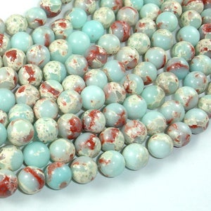 May include: A strand of round, light blue and white marbled beads with red and brown accents. The beads are approximately 10mm in diameter.