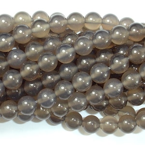 May include: A strand of grey agate beads. The beads are round and smooth, with a translucent appearance.