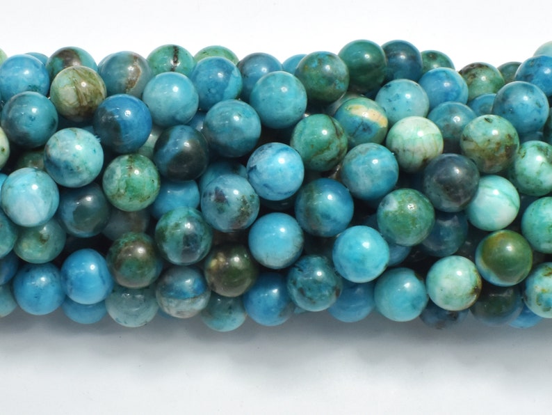 May include: A strand of round, blue and green gemstone beads. The beads have a mottled, marbled appearance.