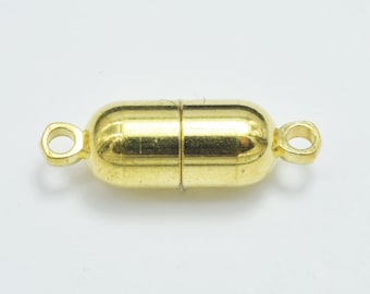 May include: Gold-toned magnetic clasp for jewellery making. The clasp is shaped like a capsule with a smooth, shiny finish.