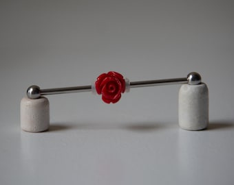 May include: A red rose charm on a silver barbell with white ceramic end caps.