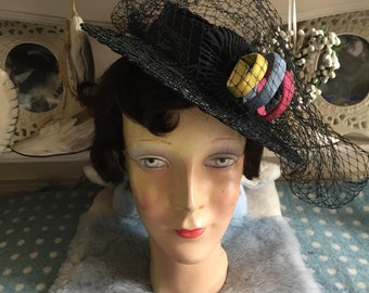 1940s black straw / raffia tilt hat with veil plus blue, pink & yellow decorative rings. See my other listings for matching dress + handbag!